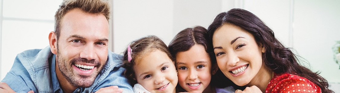 Family smiling together after a visit with their Aetna dentist in Pasadena