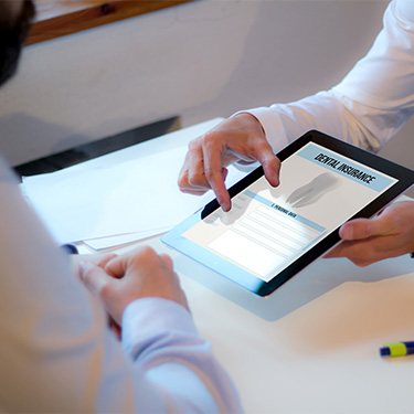 An insurance agent discussing dental insurance with a patient