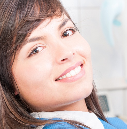 Close-up of woman in dental chair smiling