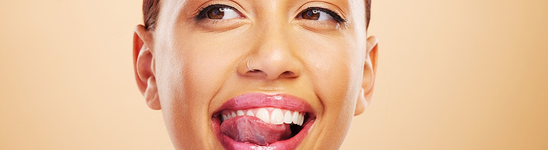 Patient in Pasadena licking smile after tooth-colored filling placement