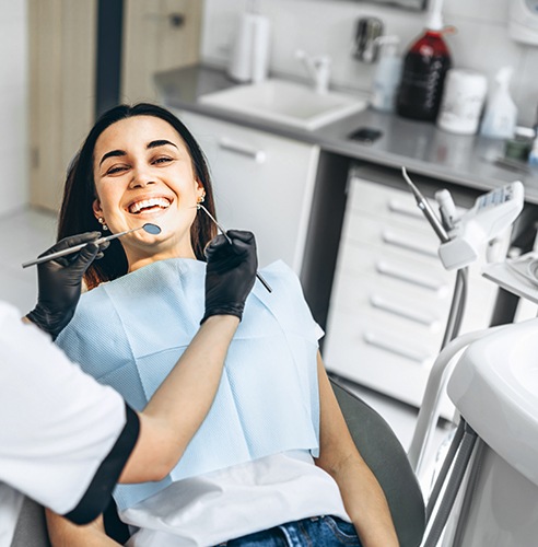 Dentist in Pasadena applying tooth-colored filling to a patient's tooth 