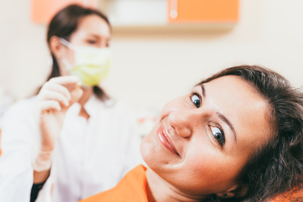 Patient smiling with dentist after wisdom teeth removal